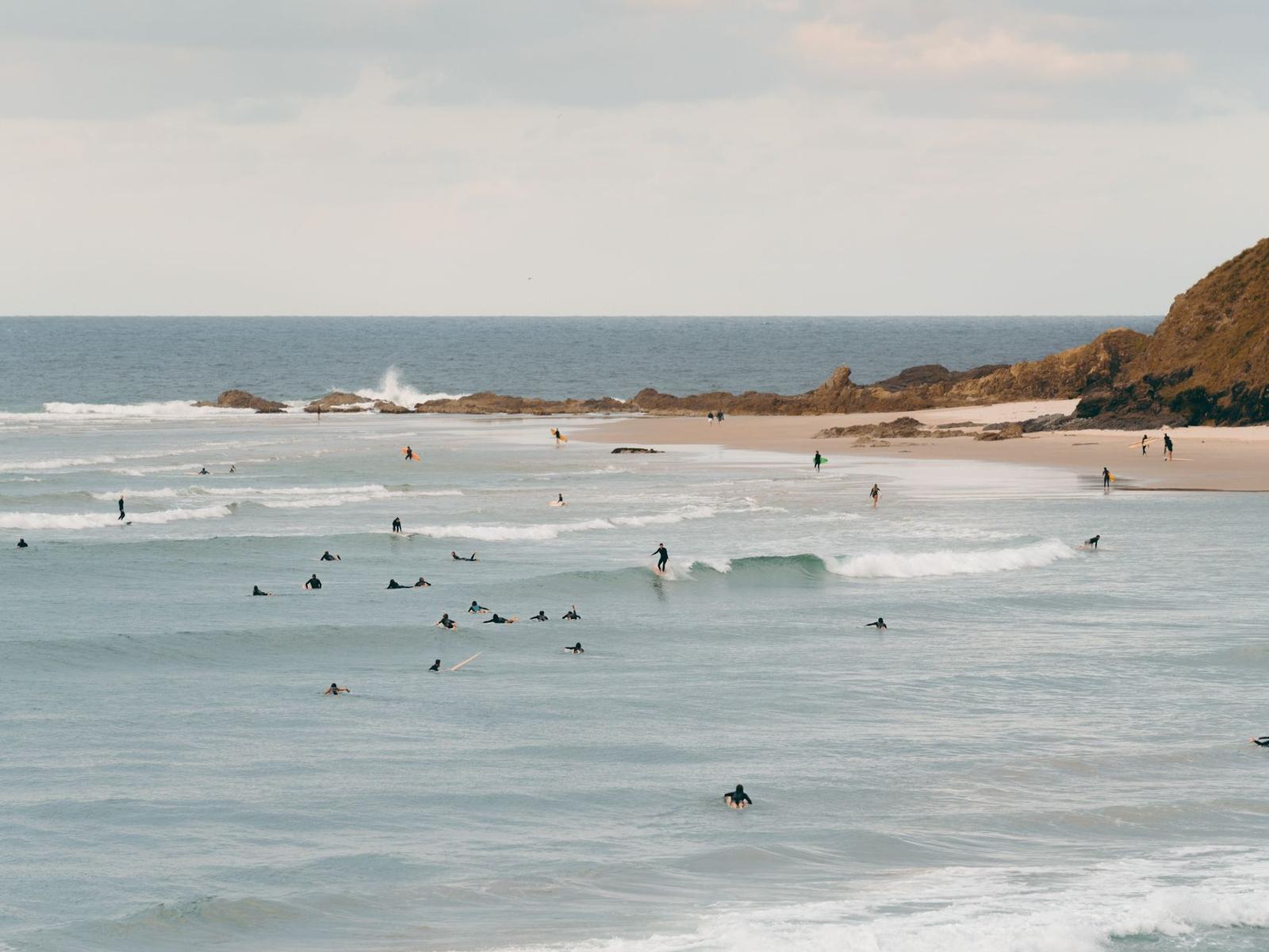 People Surfing near the Coast